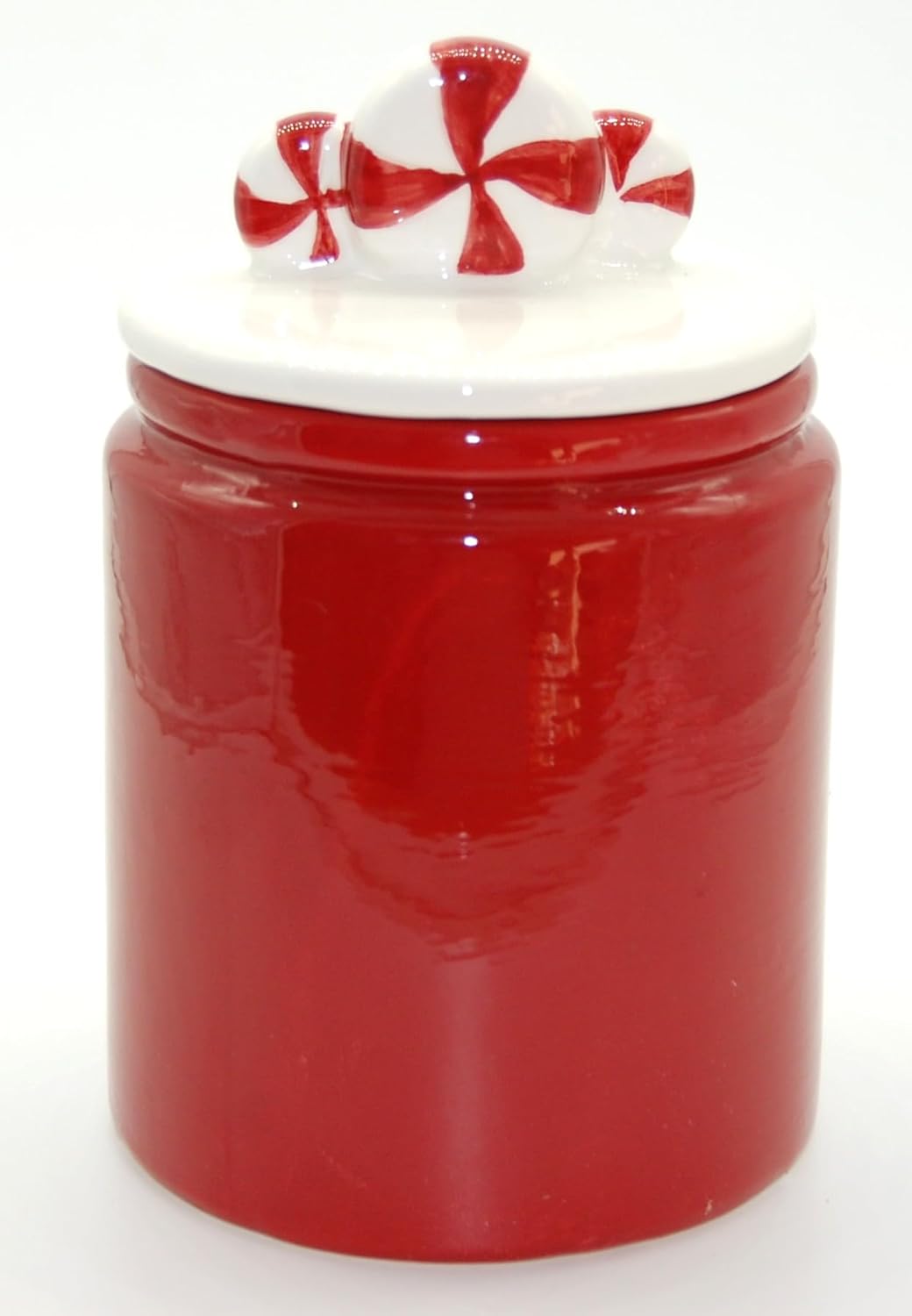 Exner Keramik Keksdose Rot, Rückansicht mit Candy-Deckel Rückseite der glänzend roten, handbemalten Exner Keramikdose. Der weiße Deckel ist mit rot-weißen Candys verziert. Die Rückseite der Dose ist glatt und ohne Schriftzug.